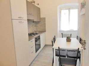 a kitchen with a table and a white refrigerator at Vista su Lerici in Lerici