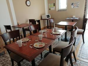 a dining room with wooden tables and chairs at Maison MooMoons in Vaubadon +59 photos