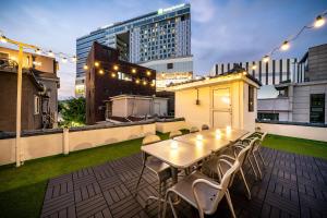 a patio with a table and chairs on a rooftop at YAB-GuestHouse, FemaleOnly, ForeignOnly in Seoul