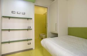 Habitación con cama y baño con estanterías. en Fiuggi apartment, en Milán