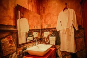 a bathroom with a sink and a mirror at Queenswood Cottage in Nuwara Eliya +45 photos