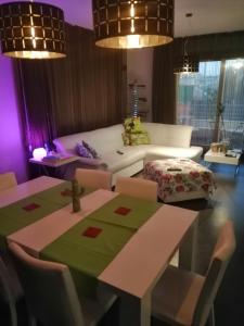 a living room with a table and a couch at Alex House in Cagliari