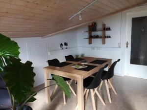 a dining room with a wooden table and chairs at Casa Luna in Ballrechten-Dottingen