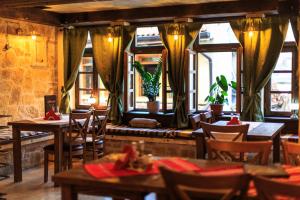 a restaurant with tables and chairs and windows at Villa Irma in Bar