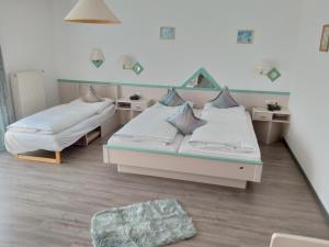 A bed or beds in a room at Landhotel Eibl
