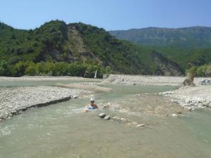 a person in the water in a river at Traditional Guesthouse Marousio in Rodavgi