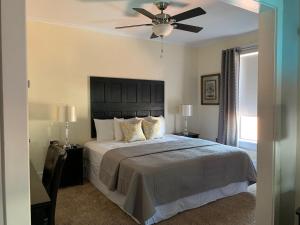a bedroom with a large bed with a ceiling fan at Hotel Garza in Post