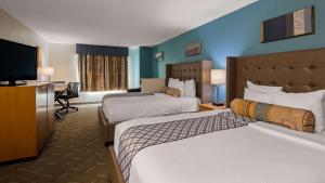 a hotel room with two beds and a flat screen tv at Best Western Plus Liberty Lake Inn in Spokane Valley +18 photos