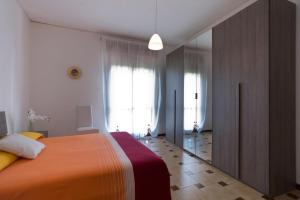a bedroom with a large bed and a large window at Casavacanza " LA CONCHIGLIA " in Sapri