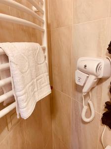 a bathroom with a hair dryer and a towel at Готельно-ресторанний комплекс «Галицький замок» in Ternopil +54 photos