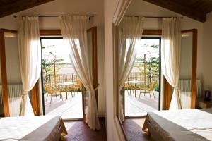 Postel nebo postele na pokoji v ubytování Agriturismo Fiumi Uniti