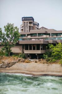 a building with a river in front of it at Centennial Hotel Spokane in Spokane