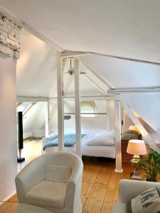 a living room with a bed and a couch at Townhouse Solingen in Solingen