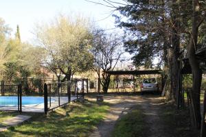 a gate with a car parked next to a pool at La sacha sin fin in Merlo