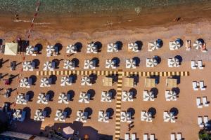 an overhead view of a beach with chairs and umbrellas at Hotel California by Aycon in Sveti Stefan