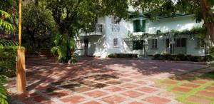 a courtyard in front of a white building at Buenavista Family Inn in Tagudin