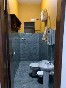a bathroom with a toilet and a sink at casa temporada tiradentes in Tiradentes