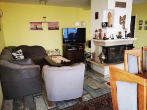a living room with a couch and a television at Villa Liana in Bozhurets