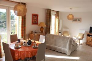 a living room with a table and chairs and a dining room at Villa Nassalia in Lorgues