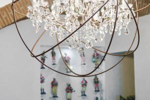 a chandelier hanging from a ceiling with figurines at Relais 147 - Luxury b&b in Taormina