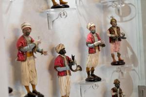 a group of figurines of men in a bathroom at Relais 147 - Luxury b&b in Taormina