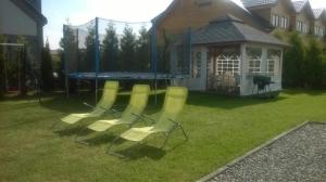 a group of chairs and a table in a yard at Adria in Sarbinowo