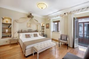 a bedroom with a large white bed and a chair at Relais 147 - Luxury b&b in Taormina +32 photos