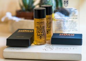 two bottles of oil sitting on a shelf next toproducts at Relais 147 - Luxury b&b in Taormina
