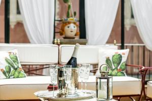 a table with a bottle of champagne and glasses on it at Relais 147 - Luxury b&b in Taormina