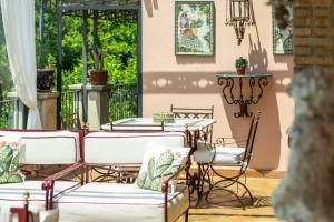 a patio with tables and chairs on a patio at Relais 147 - Luxury b&b in Taormina