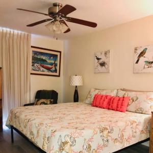 a bedroom with a bed and a ceiling fan at Nani Kai Hale in Kihei