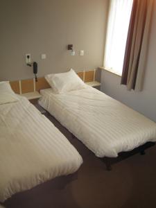 Postel nebo postele na pokoji v ubytování Hotel Ekamper