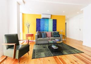 a living room with a couch and a chair at ALTIDO Avenida Apartments in Lisbon