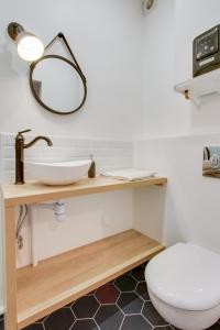 a bathroom with a sink and a toilet at Le Saint Honore in Fontainebleau