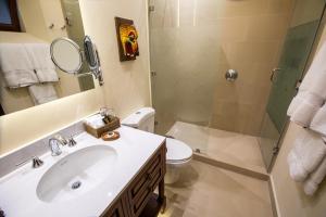 a bathroom with a sink and a shower and a toilet at Porta Hotel Antigua in Antigua Guatemala