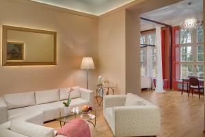 a living room with a white couch and chairs at Chateau Herálec Boutique Hotel & Spa by L'Occitane in Herálec