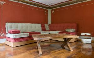 a living room with a couch and a table at Ca’d’ambra in Groscavallo +29 photos