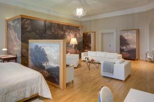 a bedroom with a large painting on the wall at Chateau Herálec Boutique Hotel & Spa by L'Occitane in Herálec