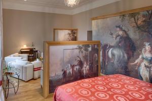 a bedroom with a large painting on the wall at Chateau Herálec Boutique Hotel & Spa by L'Occitane in Herálec