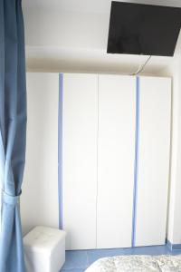 a bedroom with a bed and a flat screen tv at Il Sestante B&B in Condofuri