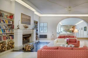 a living room with a red couch and a fireplace at Chateau Herálec Boutique Hotel & Spa by L'Occitane in Herálec