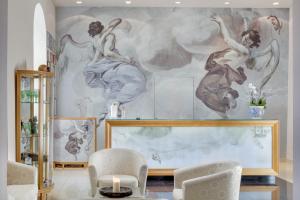 a mural of women dancing on a wall in a living room at Chateau Herálec Boutique Hotel & Spa by L'Occitane in Herálec