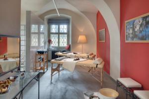 a room with a bunch of beds in it at Chateau Herálec Boutique Hotel & Spa by L'Occitane in Herálec