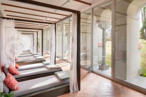 a room with glass walls and a porch at Chateau Herálec Boutique Hotel & Spa by L'Occitane in Herálec