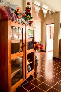 a wooden cabinet with glass doors in a room at Hotel San José de la Montaña in San Salvador