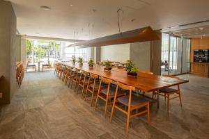 a long dining room with a long table and chairs at Hotel Oriental Express Tokyo Kamata in Tokyo