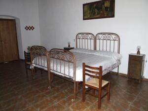 a bedroom with two beds and a table and chairs at Antico Frantoio in Cerchiara di Calabria