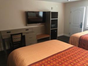 
a hotel room with a bed and a television at Presidio Parkway Inn in San Francisco
