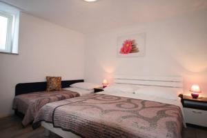 Ein Bett oder Betten in einem Zimmer der Unterkunft Apartments Hodzic