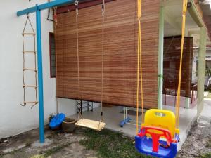 a swing outside of a house with a window at 2 BR Medina Dollar Landed Homestay Cheras MRT Link in Cheras